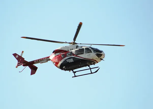 Life flight flying with blue sky background