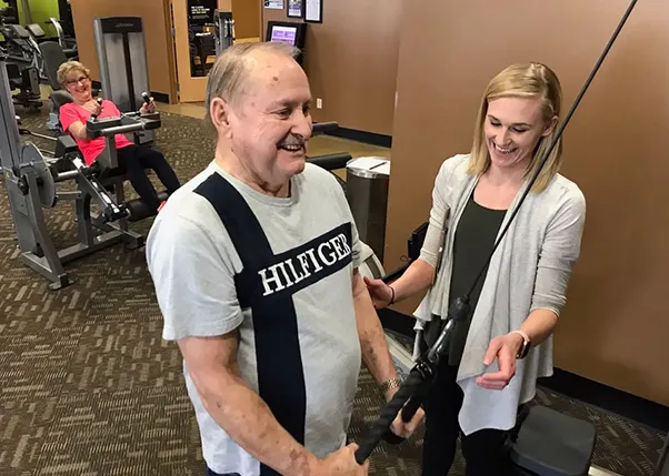 Stroke Survivor Working Out Triceps with Personal Trainer