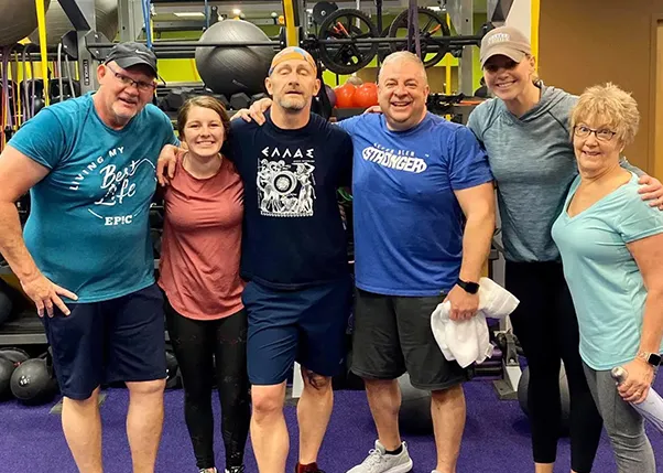 Stroke Survivor and Personal Trainers Smiling After Workout Class at Anytime Fitness