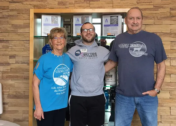 Stroke Survivor Smiling with Personal Trainer and Caregiver