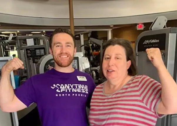 Photo of a Stroke Survivor and Her Personal Trainer Flexing for the Camera