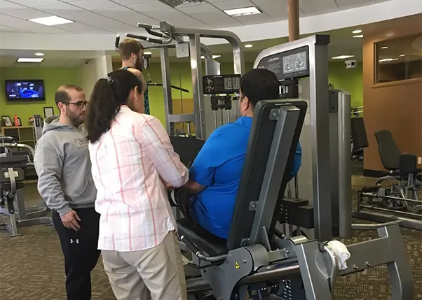 Stroke Survivor Doing Leg Exercises with Personal Trainer