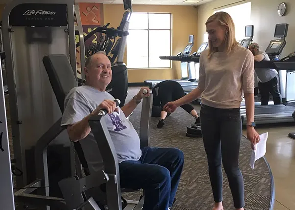 Stroke Survivor Working Out Chest with Personal Trainer